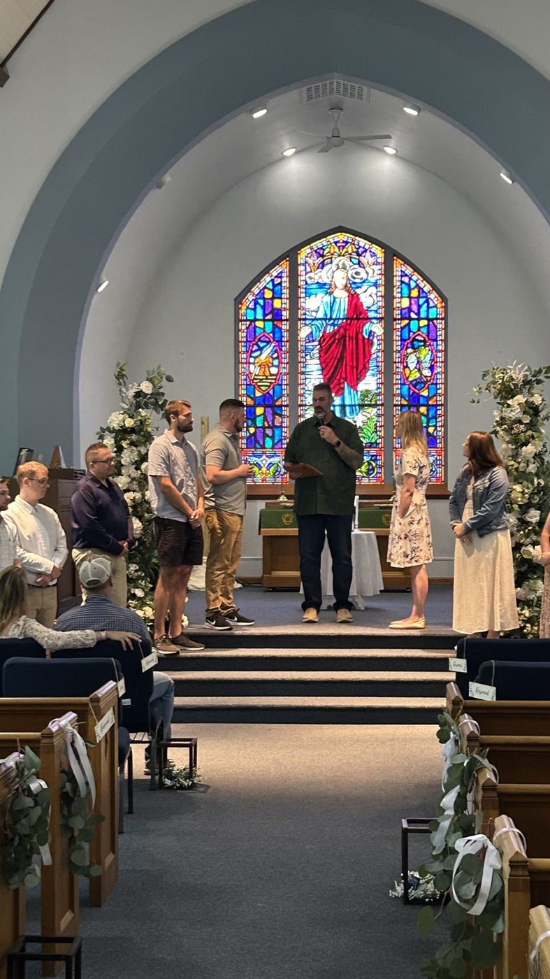 Randy officiating a ceremony at the front of a chapel