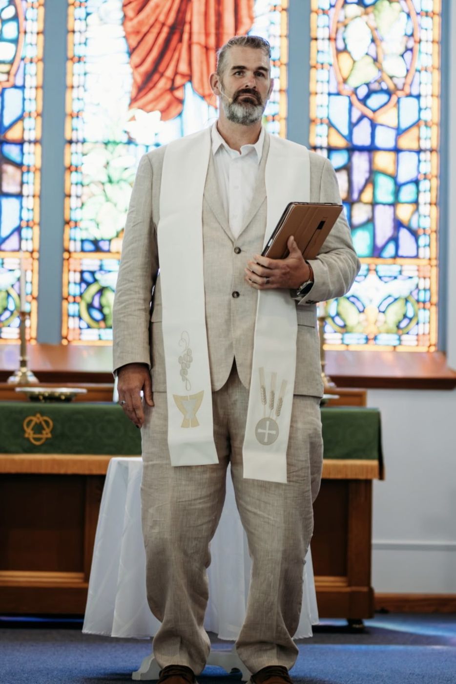 Randy Bennett officiating in a linen suit and white stole